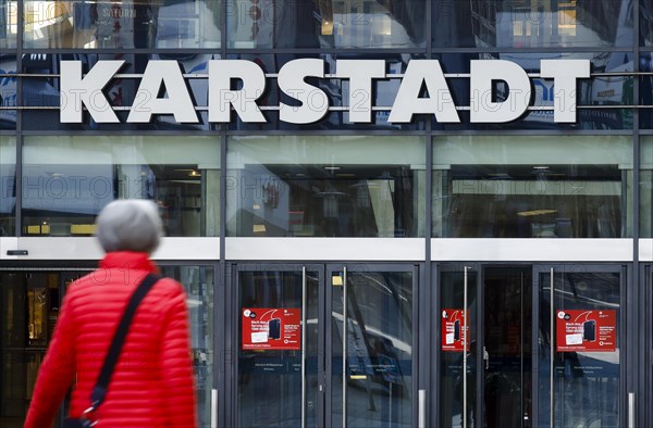 Passers-by in front of the entrance of the Galeria Karstadt Kaufhof store in the Limbecker Platz shopping centre