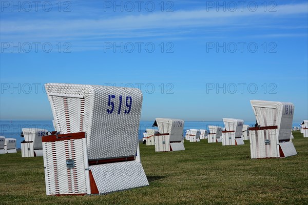 White beach chairs at the dike
