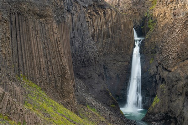 Waterfall Litlanesfoss between columnar basalt