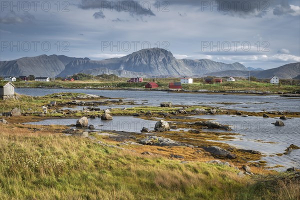 Wooden houses on a fjord at low tide