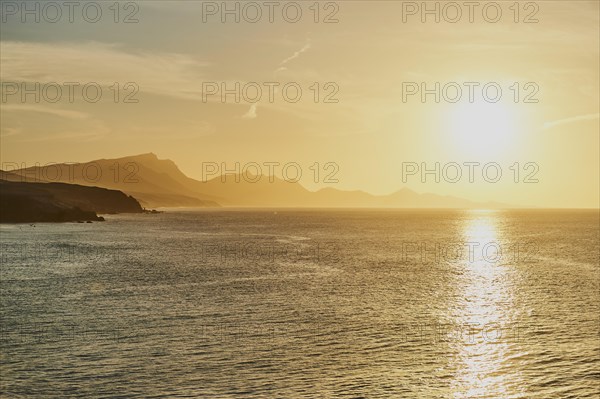 Rocky coast near beach Playa de la Pared at sunset