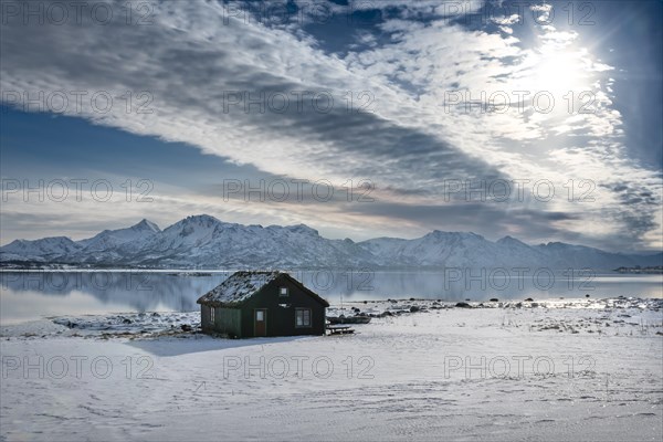Wooden house in winter landscape