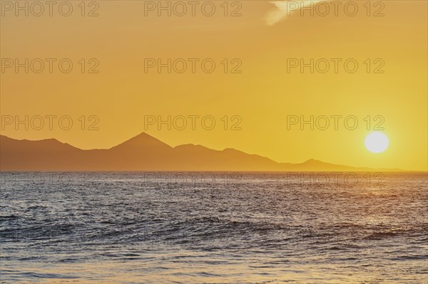 Rocky coast near beach Playa de la Pared at sunset