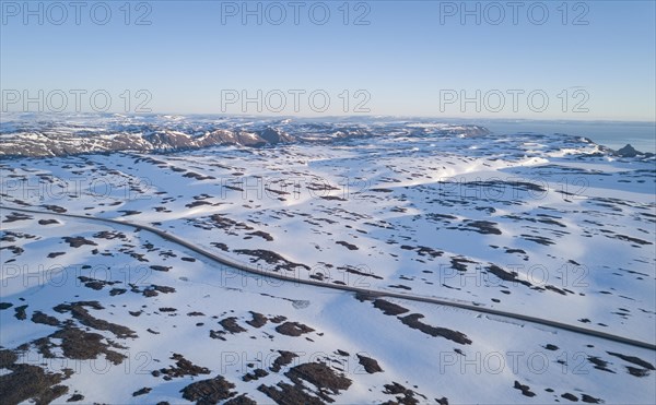 Lonely road to the North Cape in snow covered arctic landscape by car