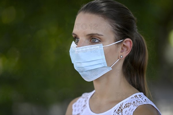 Woman wears mouth mask correctly over nose and mouth