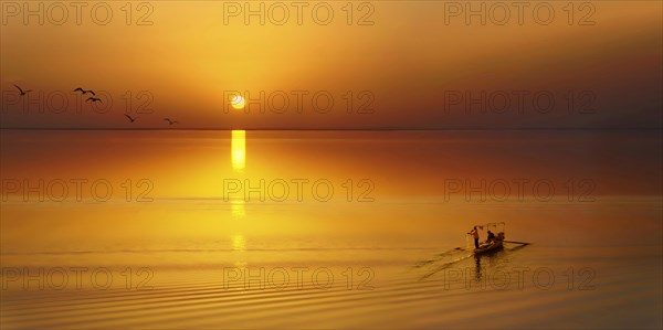 Fishing boat with seagulls at sunset