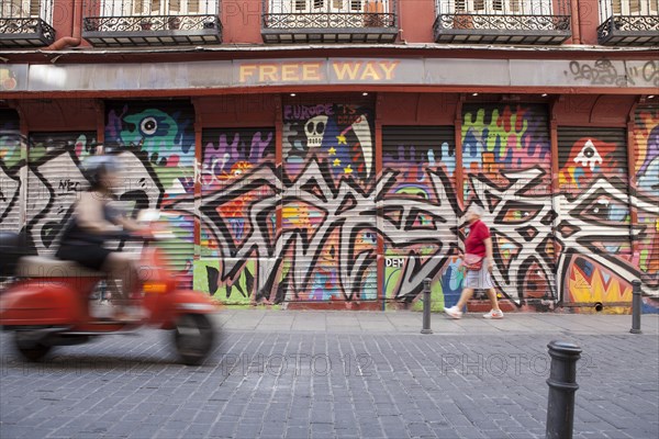 Row of shops with graffiti in the Malasana district