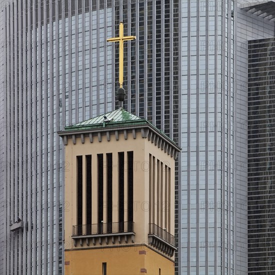 Old bell tower of the Matthaeuskirche in front of the modern aluminium facade of the Pollux office tower