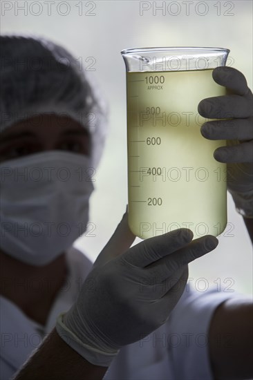 Employee measures rosemary oil at the cosmetics factory in Itupeva