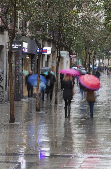 Residents and tourists walk by the most famous Fuencarral street