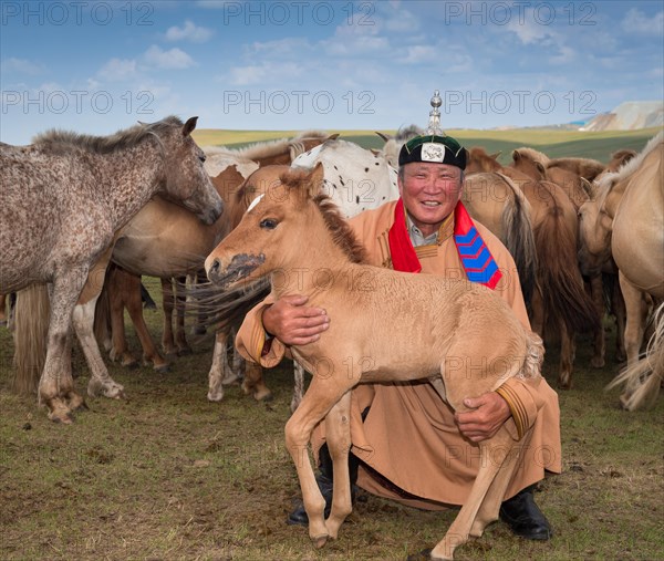 Shepherd with foal in front of his flock