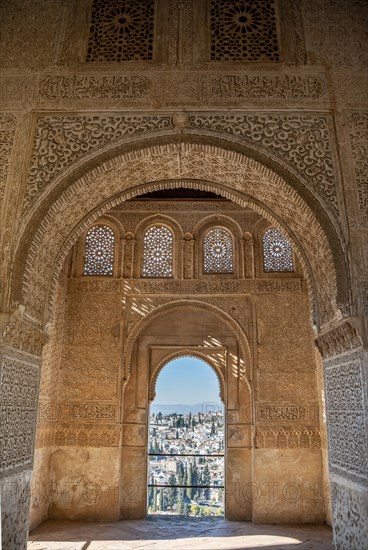 View of the Albayzin district through windows decorated with arabesques