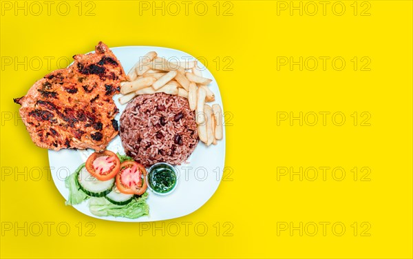 Nicaraguan food plate with yellow background with copy space