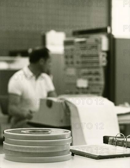 Programmer at the printer in front of the input head