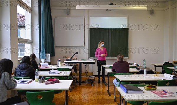 Teacher with face mask in classroom