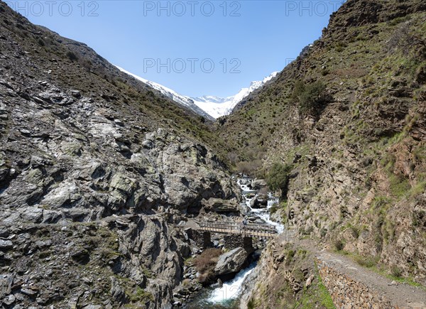 Hiker on bridge at the hiking trail Vereda de la Estrella