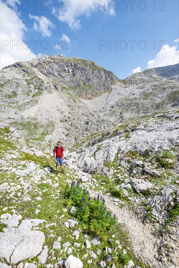 Hikers in a landscape of washed out karst rocks