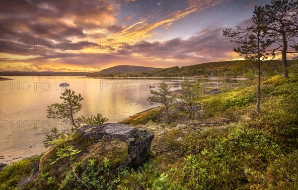 Midnight sun in midsummer by the fjord