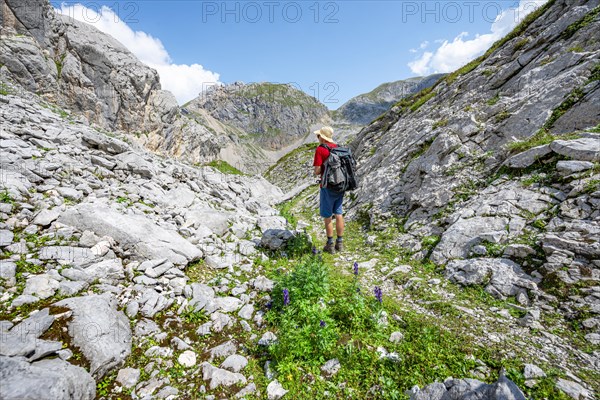 Hikers in a landscape of washed out karst rocks