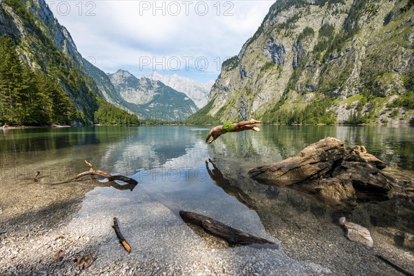 Young man jumps into lake