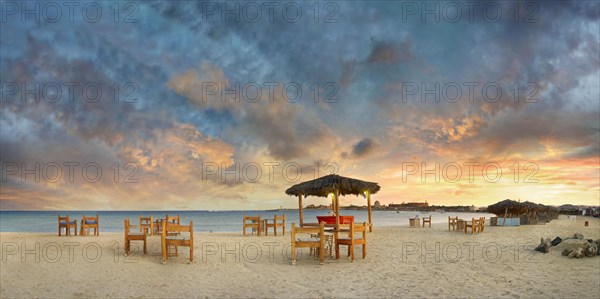 Sandy beach beach with bar at the coral reef Abu-Dabbab at sunset