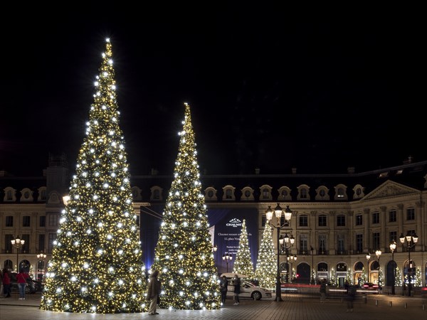 Night shot of illuminated Christmas trees at Place Vendome
