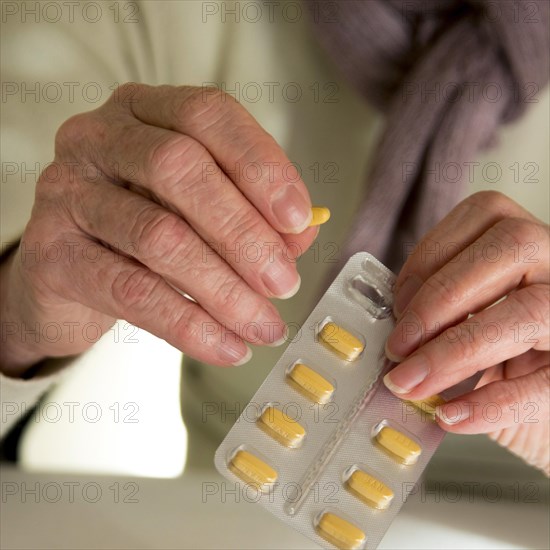 Woman holding medication pill