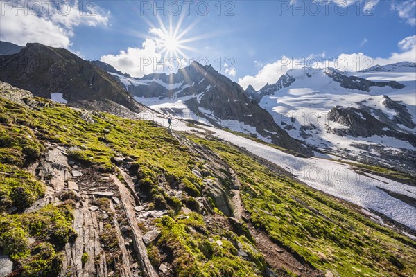 Hikers in front of snow-covered mountains