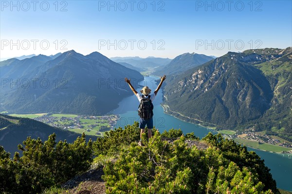 Hiker stretches arms in the air