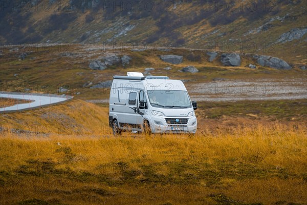 Campervan parked on grassed parking lot near Kafjord