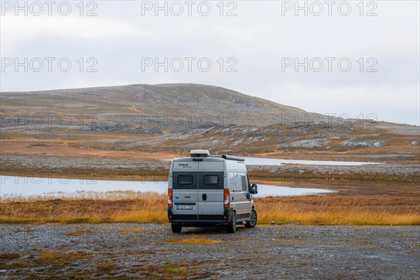 Campervan with rear view stands on parking lot near Kafjord