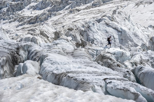 Climber walking on rutted glacier
