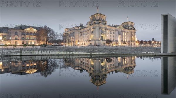Reichstag with waving German flag at the Spree