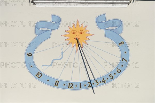 Sundial on house wall