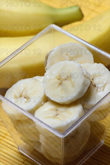Banana slices in peel and bananas