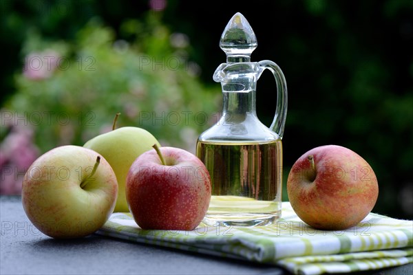Carafe with apple vinegar and apples
