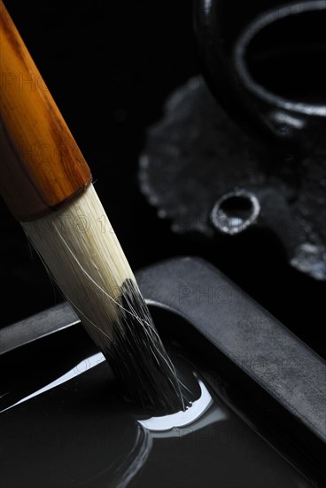 Brush with rubbing stone and water jar