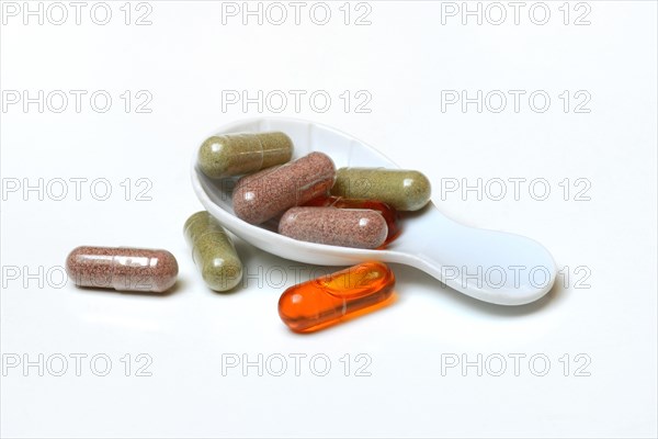 Capsules in porcelain spoon