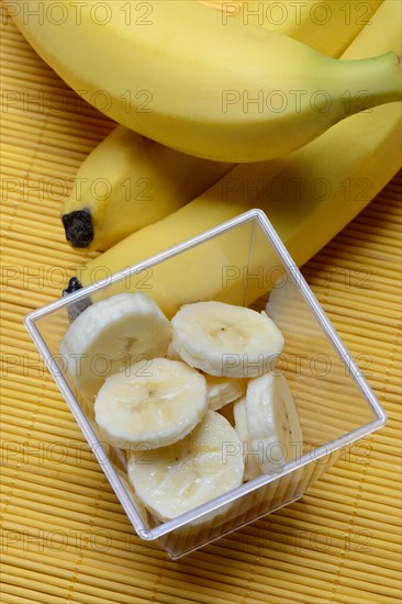 Banana slices in peel and bananas