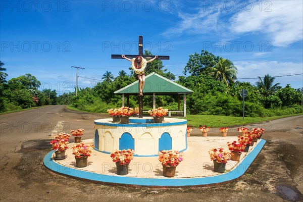 Christian statue at a road bend