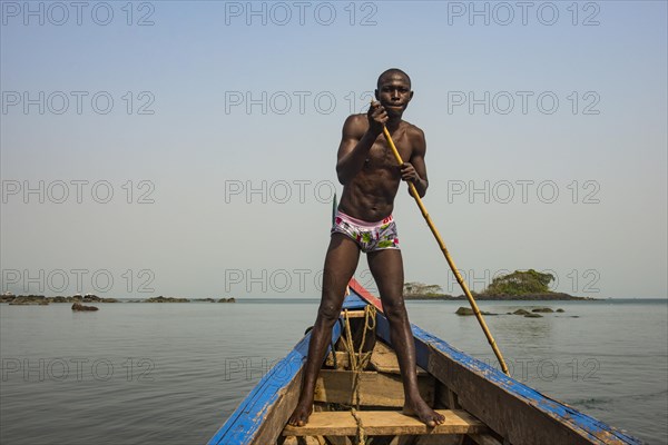Man pushing his small boat on Banana islands