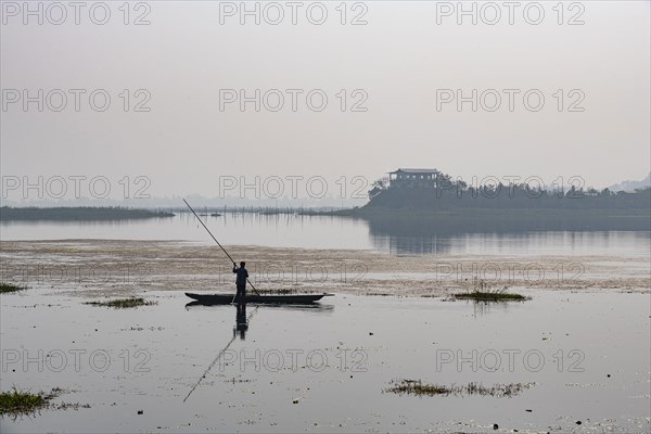 Fisherman in his canoe fishing