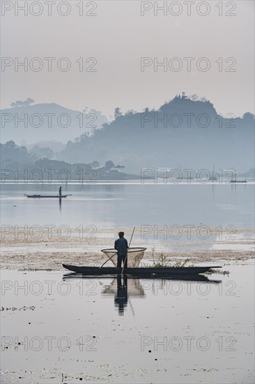 Fisherman in his canoe fishing