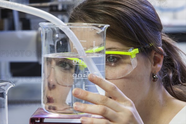 Doctoral student during her research work on a film drawing bench at the Institute for Pharmaceutical Technology and Biopharmacy at Heinrich-Heine-University Duesseldorf