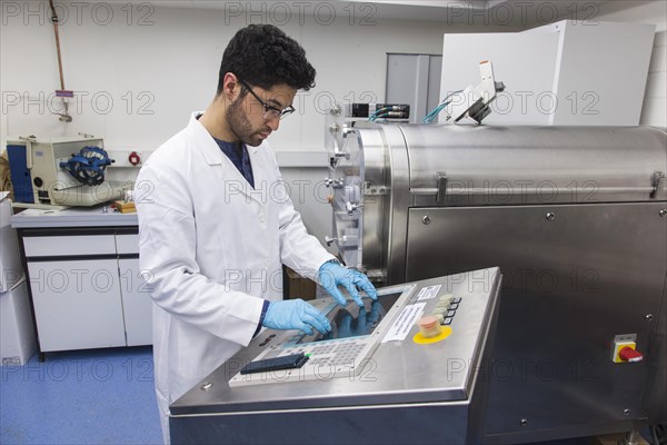 Scientists during their research work on a tablet press at the Institute for Pharmaceutical Technology and Biopharmacy at Heinrich-Heine-University Duesseldorf