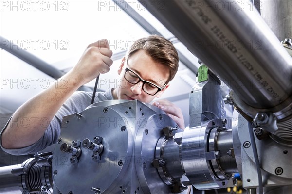 PhD student during his research work adjusting his experimental setup