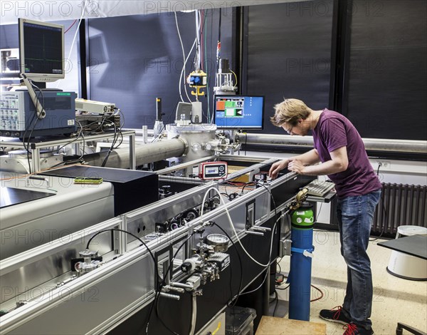 PhD student during his research work adjusting his experimental setup