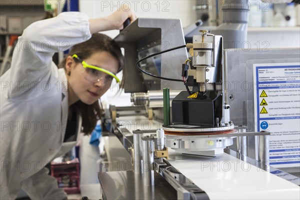 Doctoral student during her research work on a film drawing bench at the Institute for Pharmaceutical Technology and Biopharmacy at Heinrich-Heine-University Duesseldorf