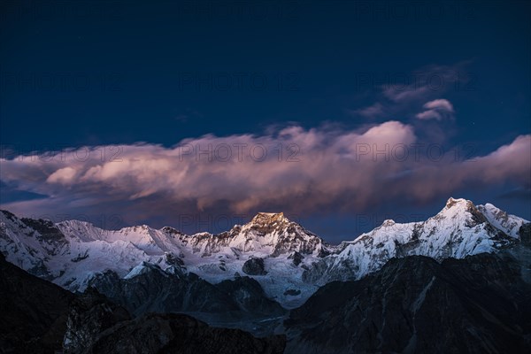 View in the evening light from Renjo La Pass 5417 m to the east on Himalaya with Gyachung Kang