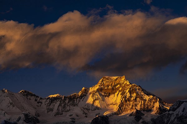 View in the evening light from Renjo La Pass 5417 m to the east on Himalaya with Gyachung Kang